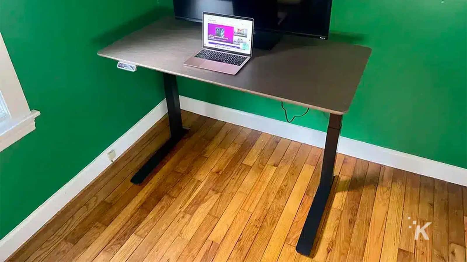 The laptop sits on the table.