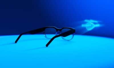 A blue surface holds a pair of glasses.