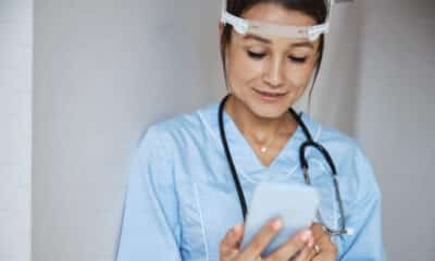 Healthcare worker looking down at phone