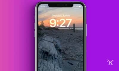 iPhone lock screen with picture of a sunset at the beach.