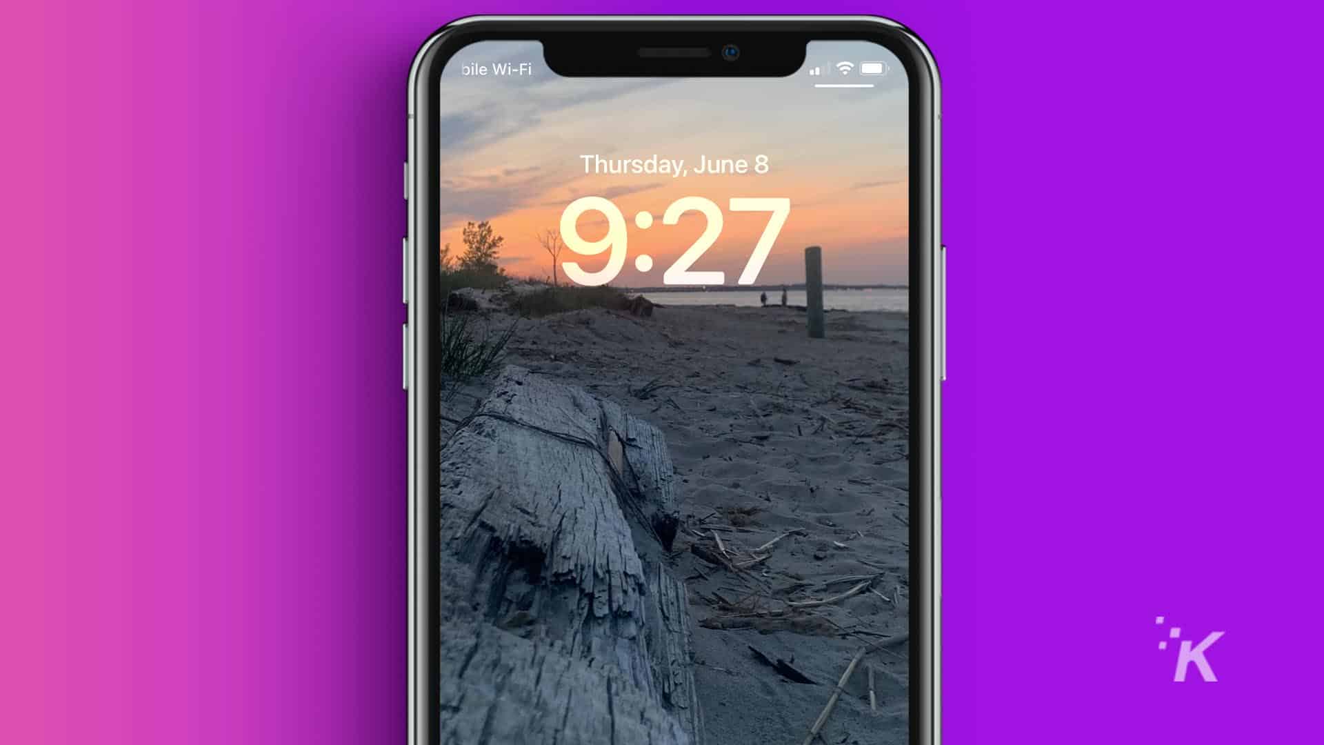 iPhone lock screen with picture of a sunset at the beach.
