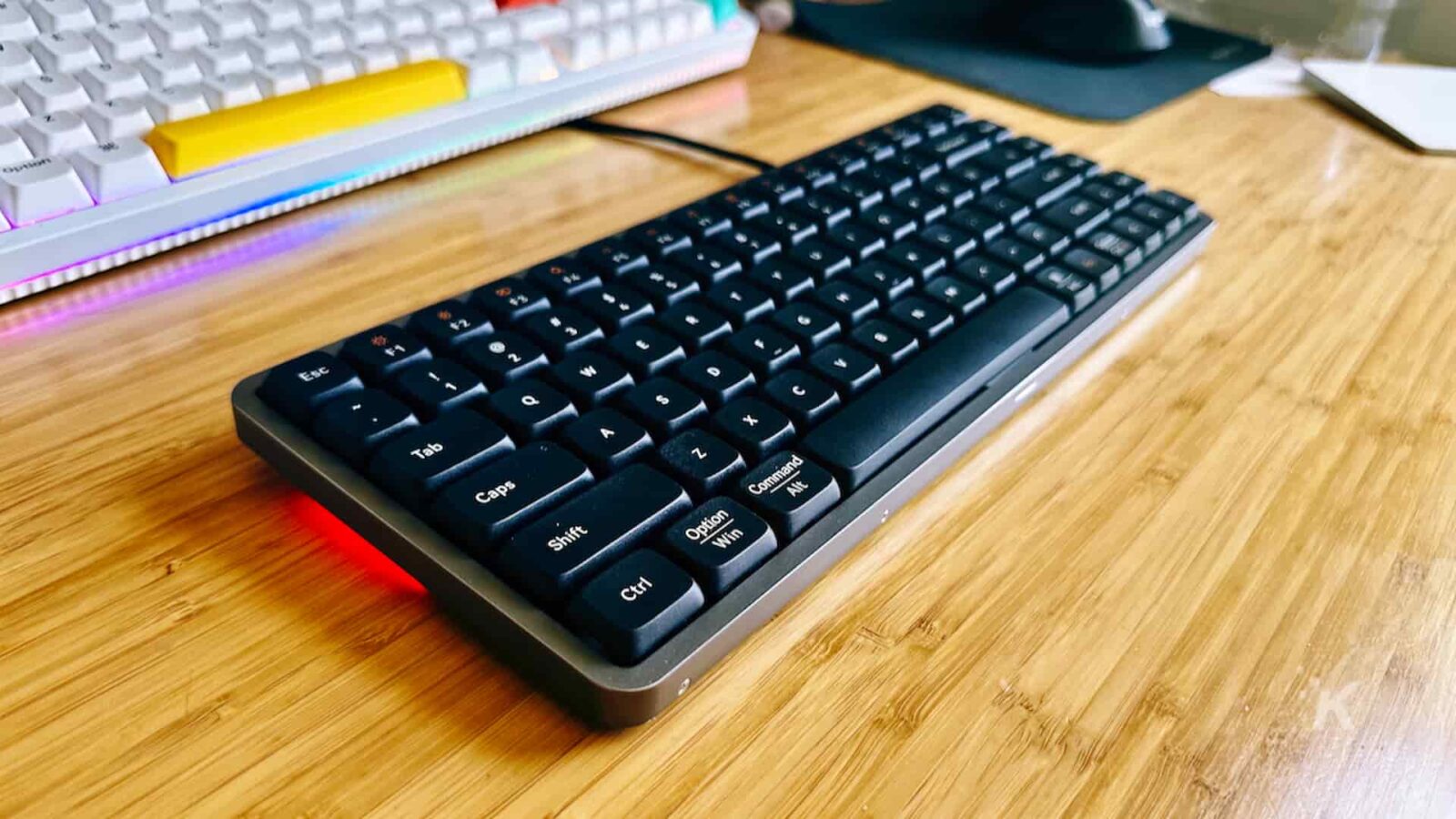 A lowfree flow mechanical keyboard sits on the table.