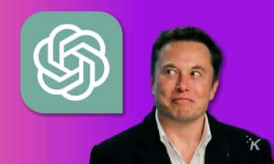 Musk looking at the ChatGPT logo