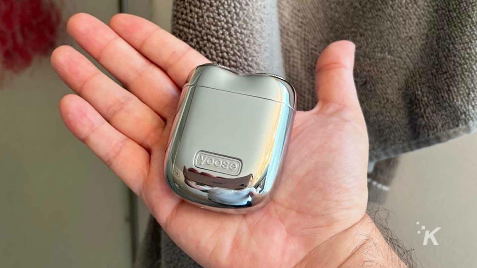 A person holds the yoose mini shaver in their hand