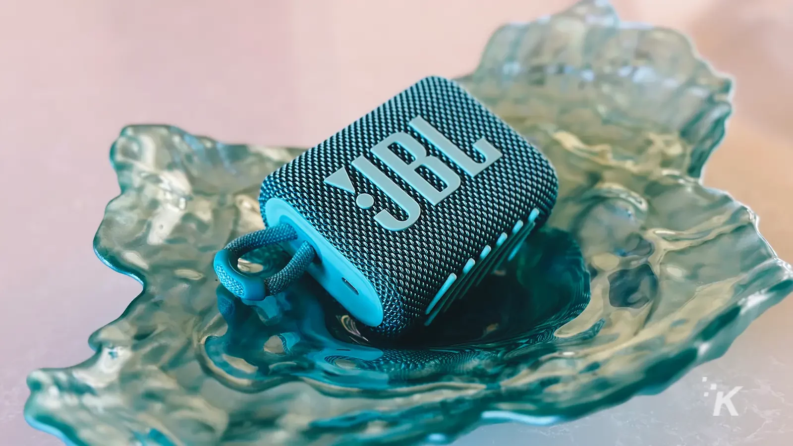JBL Go 3 portable speaker teal on a tray